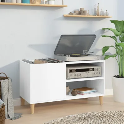 A white record cabinet with a turntable and amplifier on top, placed in a room with a plant and a rug.