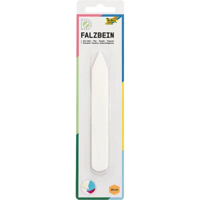 A white bone folder tool is packaged in a clear plastic blister pack on a white background. The packaging has colorful graphic elements and text.