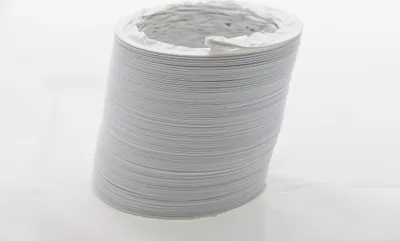 A roll of flexible white hose on a white background.