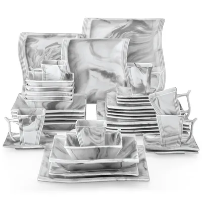 A collection of marble-patterned dinnerware is neatly arranged on a white background.