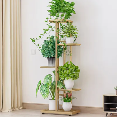 A multi-tiered plant stand filled with various potted plants, placed indoors next to a cream-colored curtain.