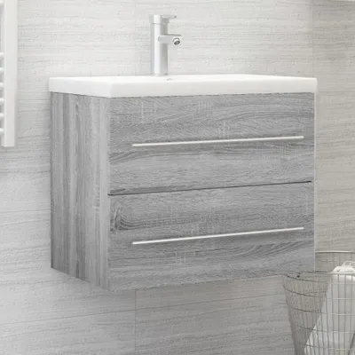 A bathroom vanity cabinet with a sink and faucet mounted on a tiled wall.
