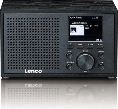 A black Lenco digital radio is shown from the front, with its screen displaying station information and song details. The radio is placed on a reflective surface, creating a mirror image below it.