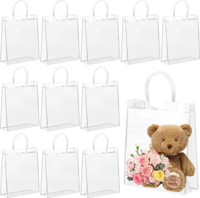 A collection of clear gift bags, with one bag containing a teddy bear and flowers.