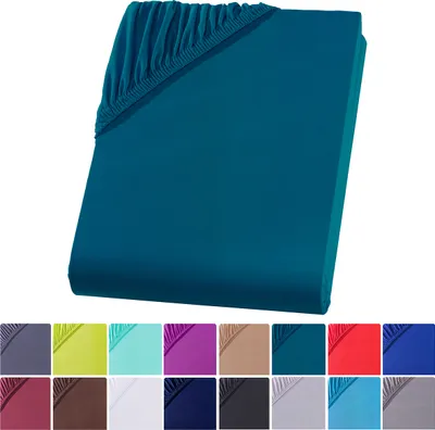 A teal fitted sheet is shown diagonally against a white background. Below the sheet are swatches of different colored fitted sheets.