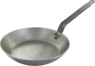 A carbon steel frying pan on a white background.