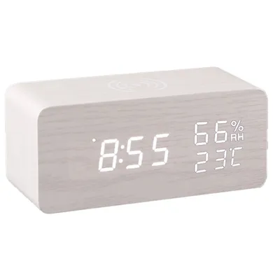 A digital alarm clock with a wood-like finish is shown against a white background.