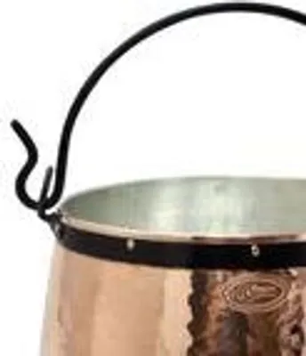 A close-up view of the upper portion of a copper pot with a black handle.