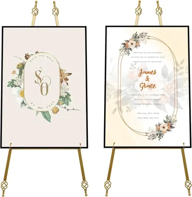 Two wedding invitation posters displayed on gold easels.