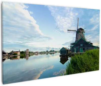 Produktbild von Wallario Premium Leinwandbild Alte Windmühle an einem Fluss in Größe 60 x 90 cm
