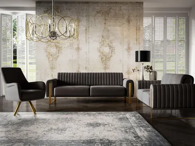 A modern living room with a sofa, armchair, and a rug.