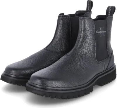 A pair of black Calvin Klein Chelsea boots on a white background.