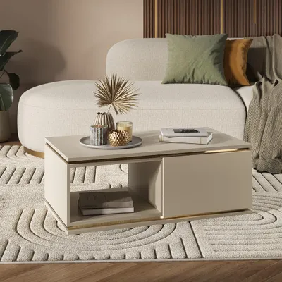 A modern living room scene featuring a couch, coffee table, and rug.