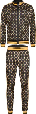 A black tracksuit with a gold fleur-de-lis pattern, featuring a zip-up jacket and matching trousers, displayed against a white background.