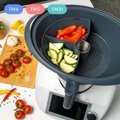 A kitchen appliance with a food preparation accessory filled with chopped vegetables.