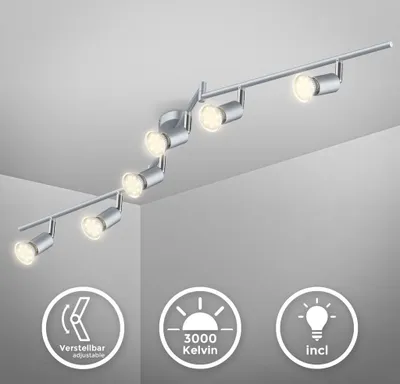 A silver-colored track lighting fixture with multiple adjustable spotlights mounted on a white ceiling.