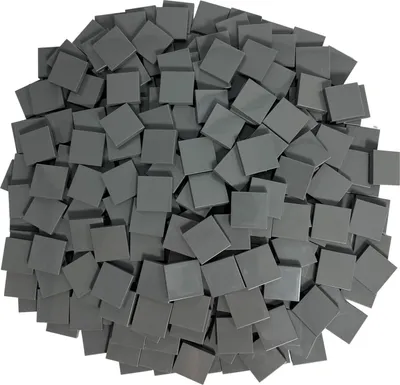 A pile of small, square, dark gray tiles.