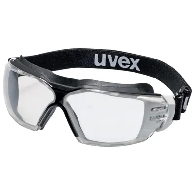 A pair of clear safety goggles with a black strap, shown against a white background.