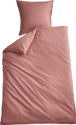 A pink duvet cover and pillowcase set laid out on a white background.