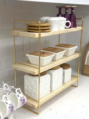 A three-tier shelf unit with various kitchen and bathroom items.