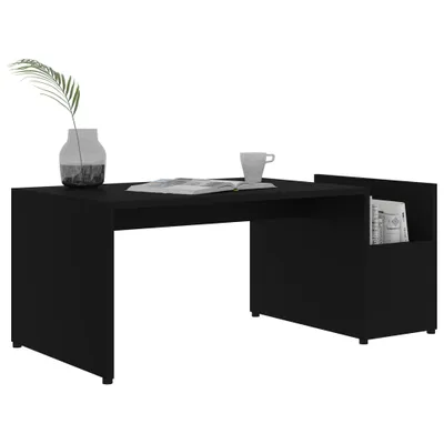 A black coffee table with a vase and a cup on it.