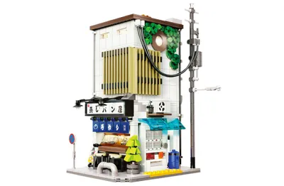 A detailed model of a Japanese-style building with a shop on the ground floor.