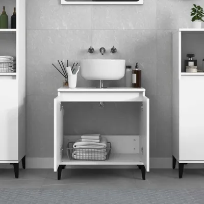 A white bathroom vanity cabinet with a sink and faucet, set against a tiled wall.