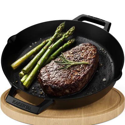 A cast iron skillet with a steak and asparagus on a wooden board.
