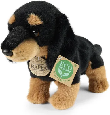 A plush toy dog with tags attached, set against a white background.