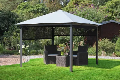 A gazebo with outdoor furniture set up in a garden.