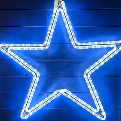 A close-up shot of a star-shaped LED light decoration against a blue wooden background.