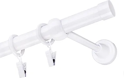 A close-up of a white curtain rod with rings and clips.
