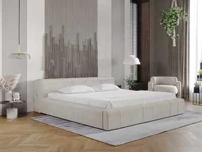 A modern bedroom with a beige upholstered bed as the focal point.
