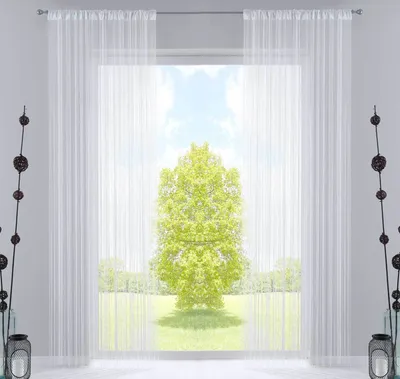 A room interior with a large window covered by sheer white curtains, revealing a view of a green tree and a grassy field under a blue sky.