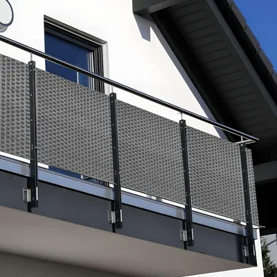 A balcony with a gray privacy screen.