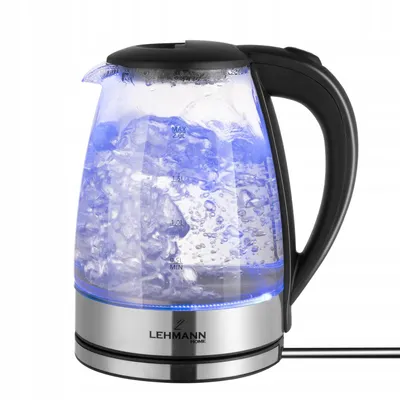 A glass electric kettle filled with boiling water, illuminated by blue LEDs.