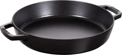 A black cast iron frying pan with two handles is shown from a slightly elevated side angle against a white background.
