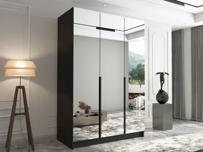 A modern bedroom with a large mirrored wardrobe, a floor lamp, and decorative items.