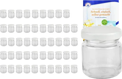 A set of small glass jars with white lids and a product packaging with text.