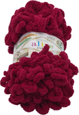 A ball of burgundy yarn with a label.