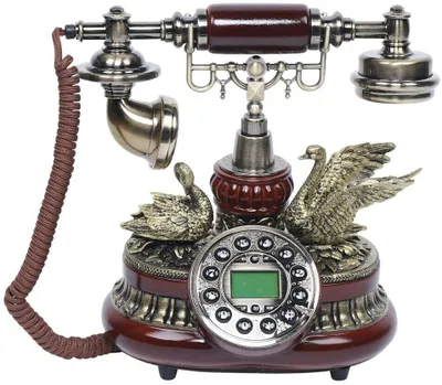 A vintage-style rotary dial telephone with decorative swan figures.