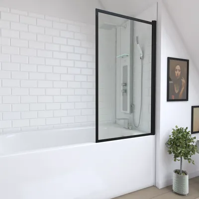 A modern bathroom with a bathtub and a glass shower screen.