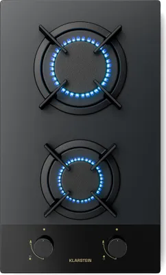 A top-down view of a black gas stovetop with two burners lit with blue flames.