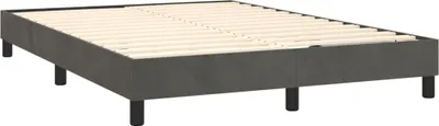 A dark gray upholstered bed frame with wooden slats and black legs, shown from a diagonal angle against a white background.