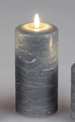 A close-up studio shot of a gray LED candle with a marble-like pattern and a lit flame.