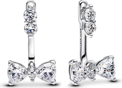 A pair of silver earrings with clear gemstones shaped like bows.