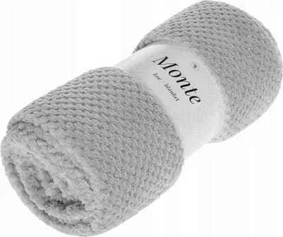 A rolled-up gray blanket with a label around it.