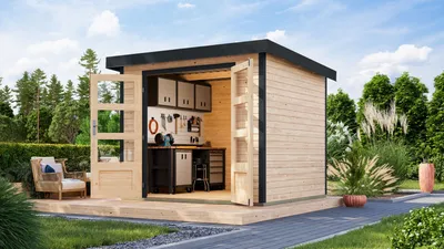 A modern wooden garden shed with open doors, revealing a workshop interior, set in a garden with trees and a paved path.