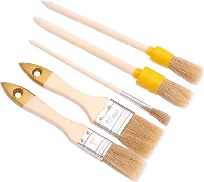 A set of five paintbrushes with wooden handles and metal ferrules, arranged diagonally on a white background.