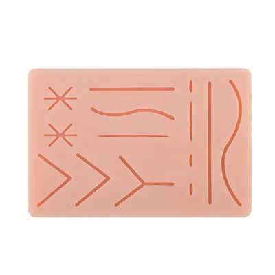A pink suture pad with various orange lines representing wounds for medical training.